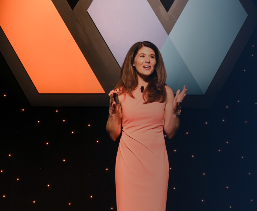 Michelle Gielan delivering keynote at large conference